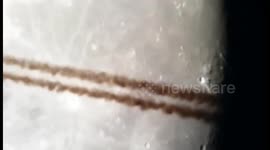 A Plane passing the Moon through a Telescope