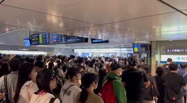 Tropical Storm Mawar disrupts Japan's bullet train services, causing long station lines