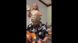 Dad & daughter being completely UNSERIOUS with their uproarious guitar-and-pan duet