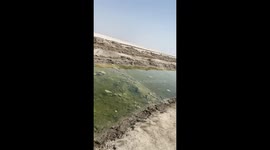 River in the middle of a massive white desert salt marsh.