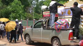 A Thai funeral procession and cremation ceremony in a village in Northern Thailand.