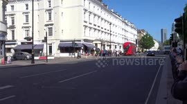 One big troll woman uses huge umbrella to block migrants protest outside Comfort Inn Pimlico in Westminster