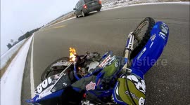 Motorcycle wheelie crashes catches on fire lucky theres snow to put it out