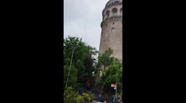 People enjoy the evening around the Galata Tower in Istanbul, Turkey