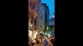 People enjoy the evening around the Galata Tower in Istanbul, Turkey