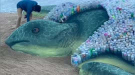 Turtle sand sculpture with shell made of 2320 plastic bottles appears on World Environment Day