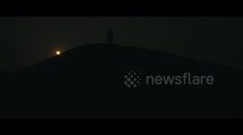 Drone operator captures STUNNING footage of Strawberry Moon rising above Glastonbury Tor