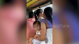 Sassy little girl gives strangers death stare while travelling on bus with mum and sister