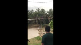 Terrifying moment: motorbike plunges into water as floating bridge swings wildly