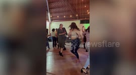 Dizzy partygoer slips on wet floor while dancing in Mexico