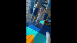Adorable toddler runs face-first into a mirror at the play area for children