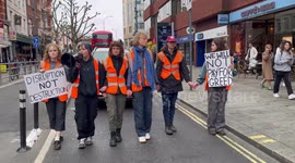 'People have to go to work!' Angry woman pushes climate protesters as they slow march through London streets