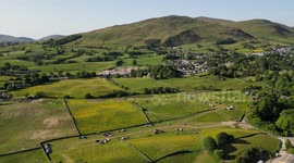 Drone shot of Cumbrian mountains and a quiet campsite at the foot of the mountain
