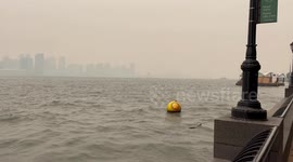 Smoke from Canada wildfires drift over New York City obscuring Statue of Liberty and New Jersey