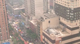 Smoky conditions from wildfires in Canada turned the streets of New York City hues of orange on Wednesday morning.