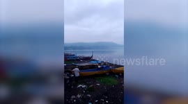 Boats set sail as Taal Volcano smog clouds lake in the Philippines