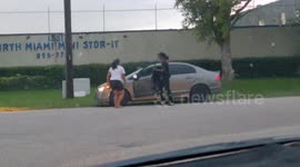 Woman Jumps on Car Hood