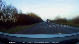 Car overtakes illegally crossing solid white lines at a a junction Dash Cam Footage
