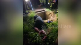 Video shows the moment a woman was reunited with her dog after it spent seven hours trapped - in a sewer pipe