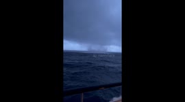 Water Spout Forms Near Cruise Ship