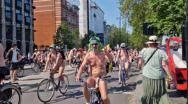 World naked bike riders bask in glorious temperatures as they pass the Houses of Parliament in London