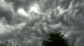 Apocalyptic scenes as huge storm cloud engulfs Birmingham, England as heavy rain, thunder and lightning strike