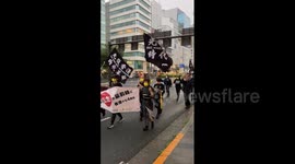Yellow-masked protesters march through Tokyo to mark Hong Kong anti-extradition law rallies