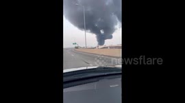 Motorist drives past plumes of thick smoke after I-95 collapse