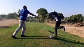 Golfer makes unexpected shot at coach's shin