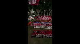 AC Milan's scarves, flowers and candles are laid outside Berlusconi's home in Arcore
