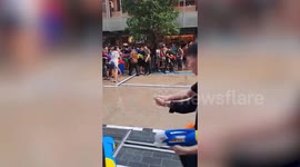 Festival-goers squirt water guns at snake when it suddenly appears during Thai festival.