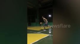Youngsters playing one-on-one basketball slip over in ball-steal fail