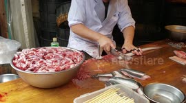Japanese chef skilfully cutting eal