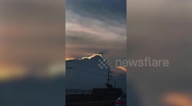 Cloud iridescence glows at sunset in Thailand
