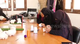 Palestinian women make toy sheep ahead of Eid al-Adha, in the Bedouin village of