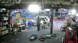 Terrified motorcycle riders run into shop when explosion rains sparks on them