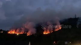 Wildfires burning in southern Wales illuminate night sky as heatwave hits UK