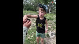 Excitement turns into sheer panic after kid realizes that the fish in his hand is ALIVE
