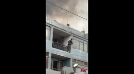 Man Scales Burning Building to Rescue Family Dog on Roof