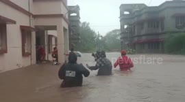 Rescuers wade through waist‐high water in India during Cyclone Biparjoy