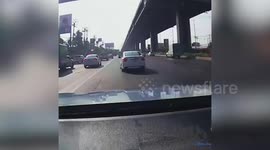 Huge motorway sign falls from bridge before landing on car windscreen