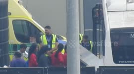 Border force loading the bus with asylum seekers from the processing center
