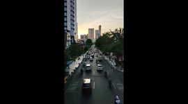 Timelapse video of a sunset cityscape with traffic jams taken from a pedestrian bridge