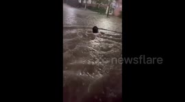 University student swims in deep floodwater as torrential rain transforms campus into pool in China