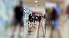 Robot dog walks with owner while shopping inside mall