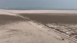 Drought makes 400-year-old stone bridge surface from lake in China