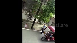 Police officer fired after pushing motorcyclist off slope in China