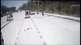Dramatic video shows scooty rider escaped speedy truck which fell road side at toll plaza