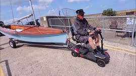 Pensioner uses mobility scooter to pull sailboat in Kent, UK