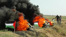 Palestinians burn tires east of Gaza city near the border fence after Israel kills 5 in Jenin raid
